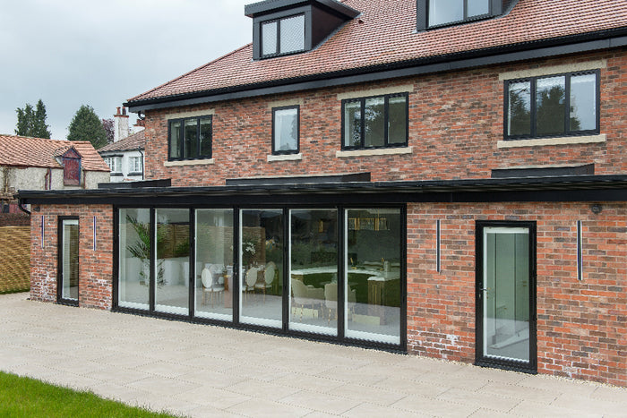Modern house with a brick exterior and large glass windows