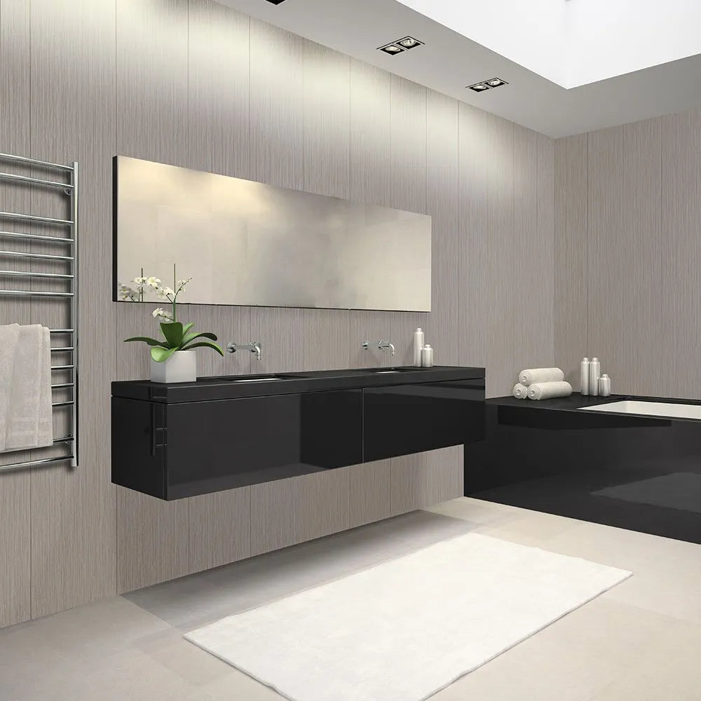 Modern bathroom interior with a floating black double-sink vanity, large rectangular mirror, light wood paneled walls, a white bath mat, towel rack, and bathtub area.