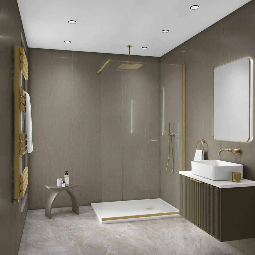 A modern bathroom interior with a walk-in shower enclosure, white vessel sink, wall-mounted vanity, rectangular mirror, gold-tone fixtures, and wood-look walls and floor.