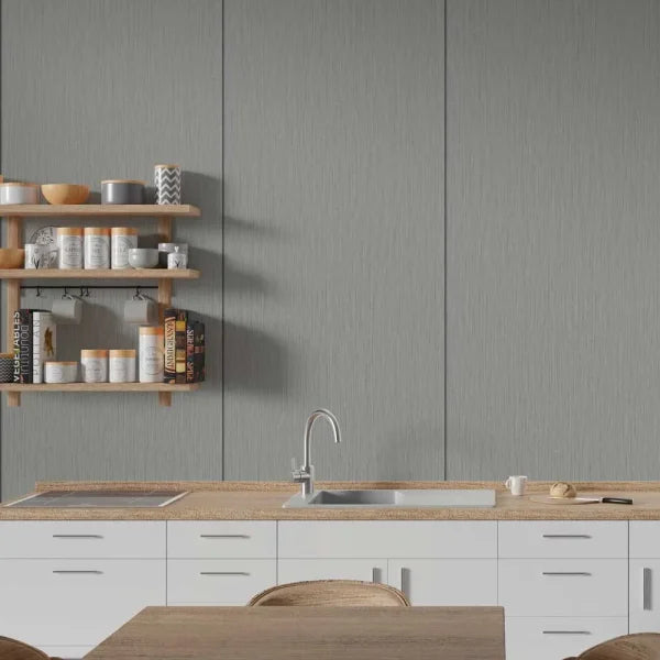 A modern kitchen interior with white cabinets, a light wood countertop, a stainless steel sink and faucet, open wooden shelves with jars and books, and a gray paneled wall behind.