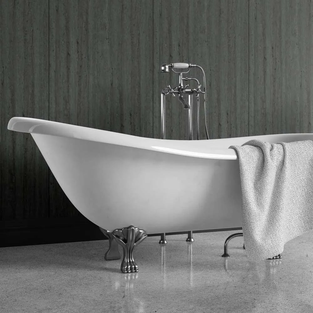 A freestanding white bathtub with ornate silver claw legs and a matching chrome faucet, shown in a bathroom setting with a gray textured towel draped over the side.
