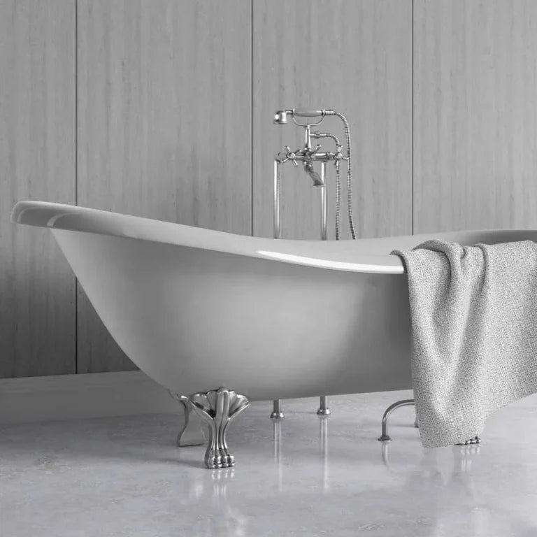 A freestanding oval bathtub with claw feet and a polished chrome faucet, shown in a bathroom setting with a gray towel draped over the side.