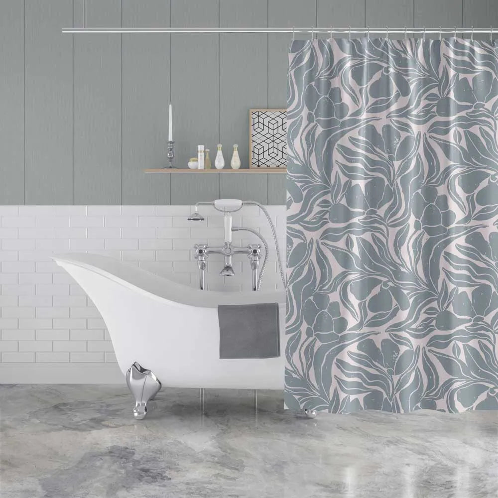 A gray and white floral patterned shower curtain hanging in a modern bathroom next to a white clawfoot bathtub.