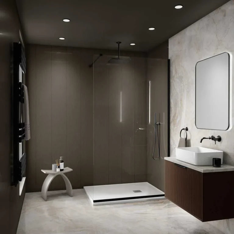 A modern bathroom interior with a walk-in shower enclosure, white vessel sink, dark wood vanity, and a large rectangular mirror on a light stone wall.