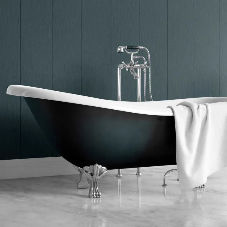 A freestanding bathtub with a glossy black exterior, white interior, and ornate silver claw feet, set against a dark blue-gray paneled wall with a white towel draped over the side.