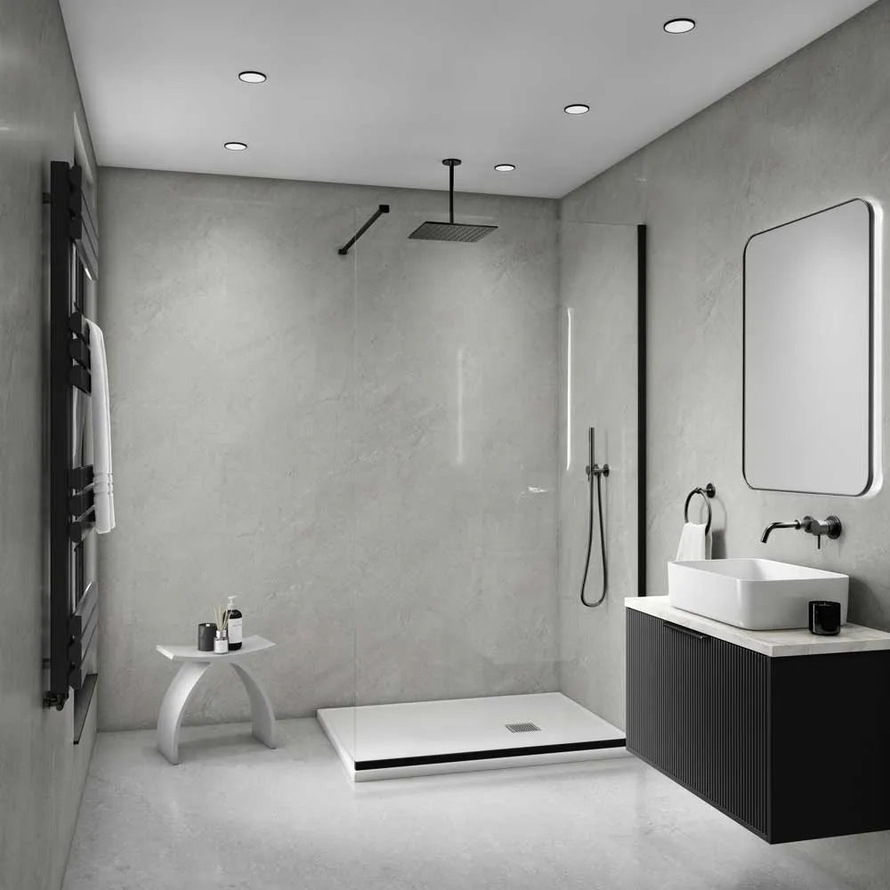 Modern bathroom interior with a walk-in shower enclosure, white vessel sink, dark floating vanity, wall-mounted mirror, black towel rail, and gray stone-look walls and floor.