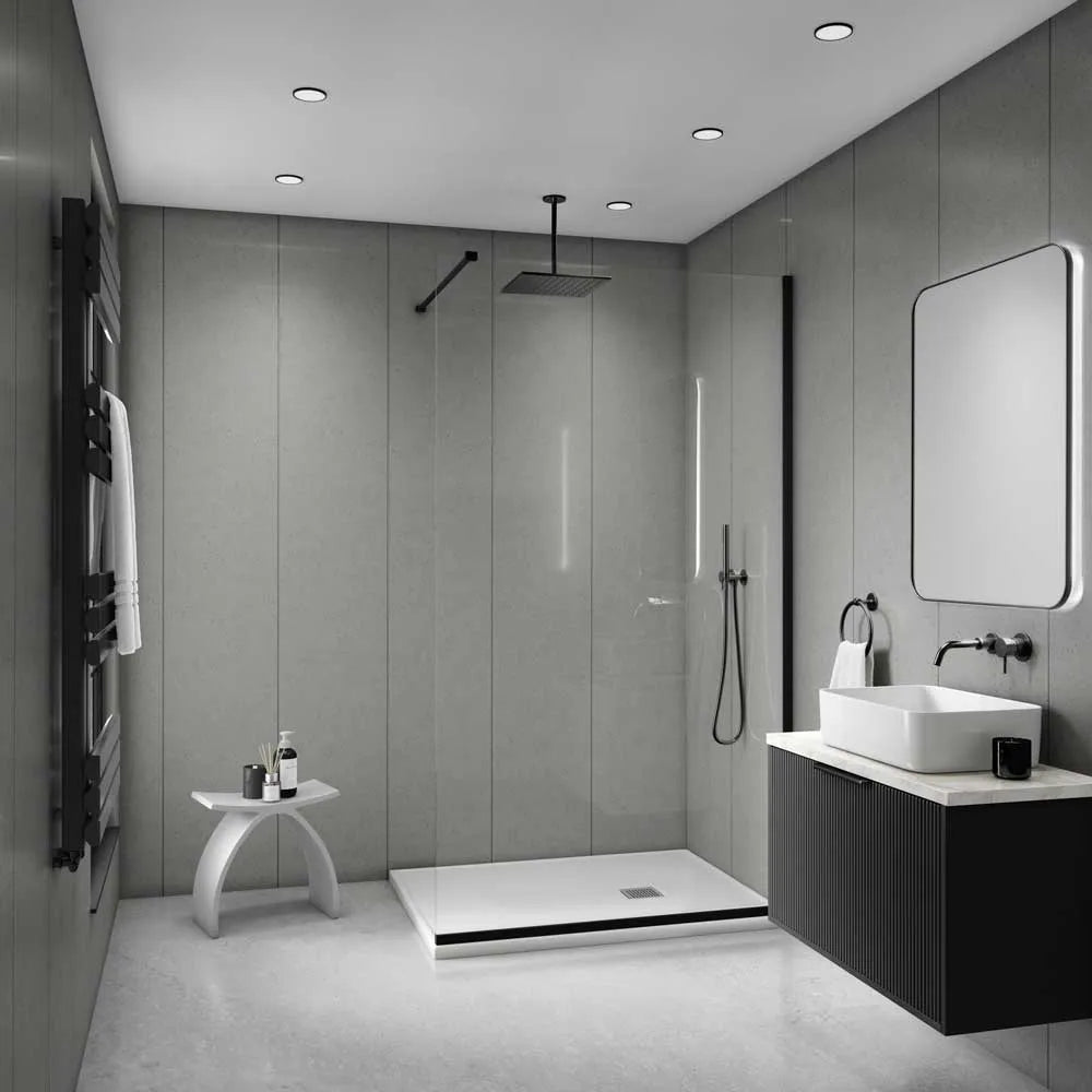 Modern bathroom interior with a walk-in shower, vessel sink, floating vanity, large mirror, and black towel rail against gray paneled walls.