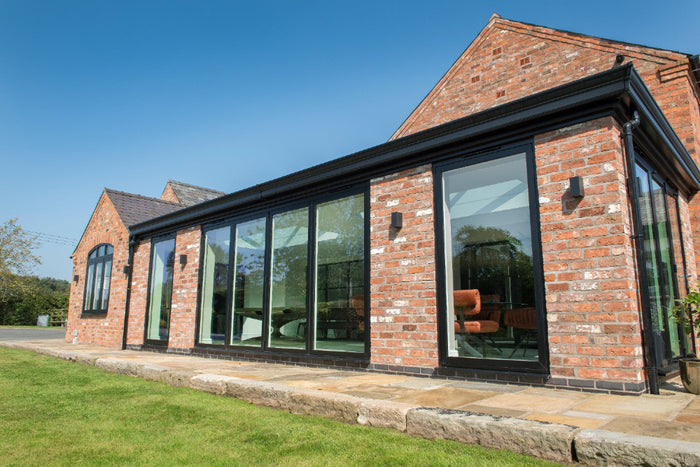 Modern brick house with large glass windows on a sunny day