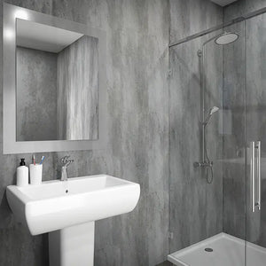 A modern bathroom featuring a white pedestal sink with a chrome faucet, a large rectangular wall mirror with a slim frame, and a glass shower enclosure with a silver shower head and hand shower.
