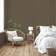 Nursery room with wooden crib, white bedding, and walnut premium slat wall panels.