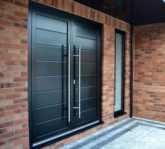 A fitted black aluminium door with bard handles