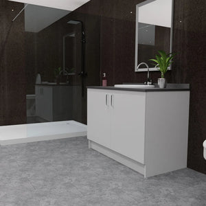 A modern bathroom vanity setup with a white cabinet, dark countertop, integrated sink, and chrome faucet, shown in a dark tiled bathroom with a walk-in shower and mirror.