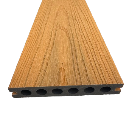 A close-up of a wood-look composite decking board with a brown grain pattern and a black multi-hole bottom edge, shown on a plain white background.