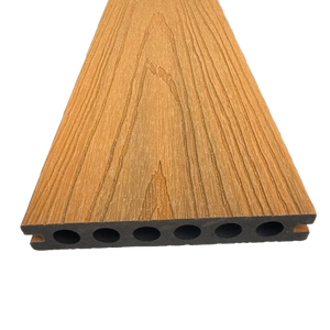 A close-up of a wood-look composite decking board with a brown grain pattern and a black multi-hole bottom edge, shown on a plain white background.
