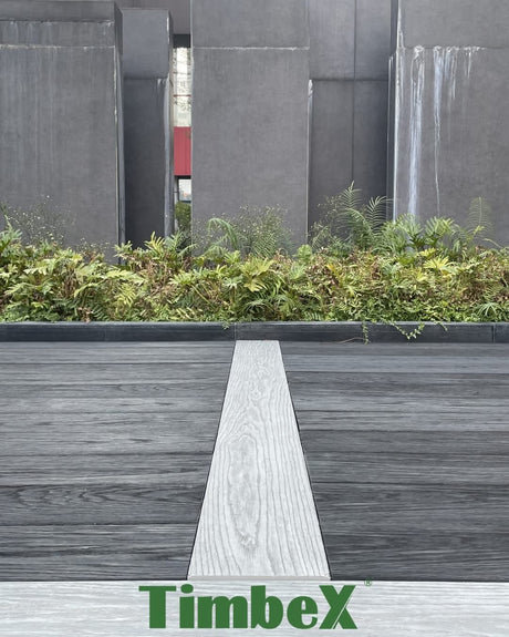 Charcoal TimbeX composite decking with a contrasting light feature board