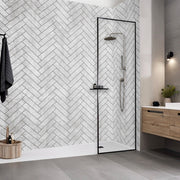 Modern bathroom with a shower area featuring a herringbone tile pattern. Cheveron grey internal wall panels 