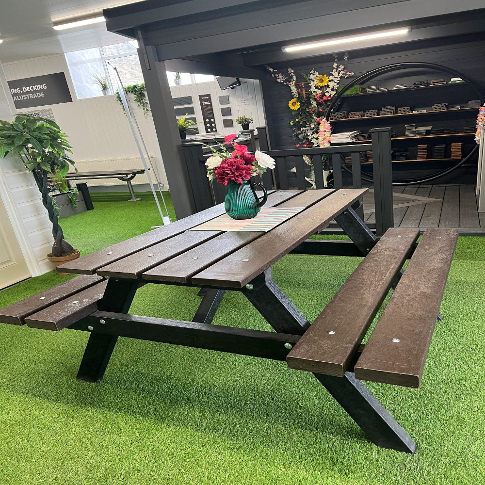 Composite picnic table with benches on a green artificial grass surface
