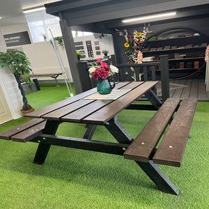 Composite picnic table with benches on a green artificial grass surface