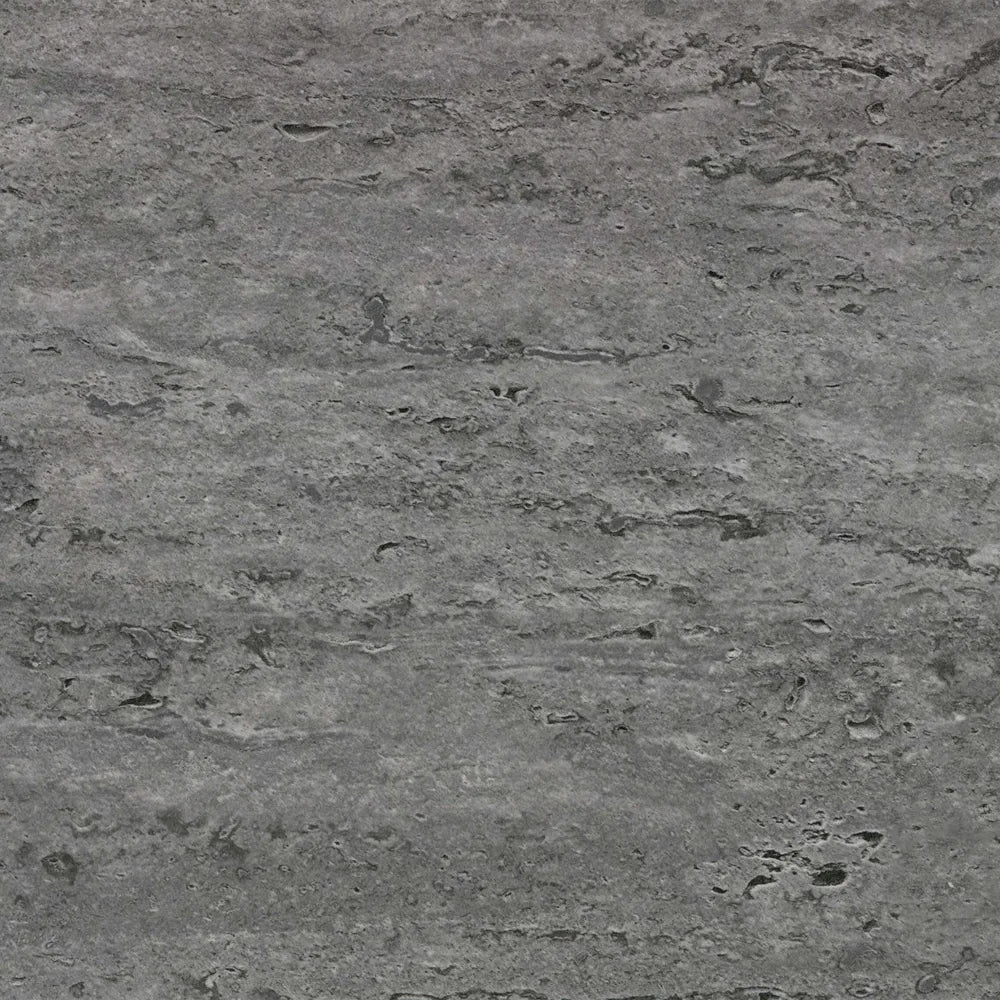 Close-up of a gray stone surface with a rough texture