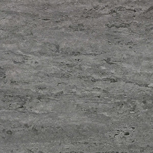 Close-up of a gray stone surface with a rough texture