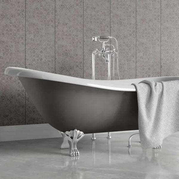 A freestanding bathtub with a matte dark gray exterior, white interior, and ornate silver claw feet, shown in a bathroom setting with a gray patterned tile wall and a draped gray towel.