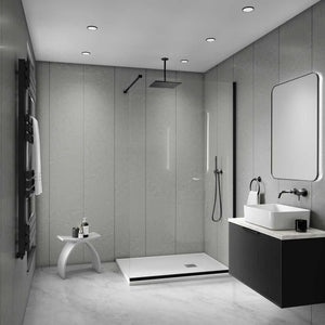 Modern bathroom interior with a walk-in shower enclosure, white vessel sink, dark floating vanity, large rectangular mirror, and gray stone-look walls and floor.