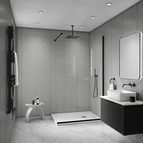 Modern bathroom interior with a walk-in shower enclosure, white vessel sink, dark floating vanity, large rectangular mirror, and gray stone-look walls and floor.
