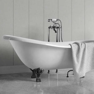 A white freestanding clawfoot bathtub with dark metal legs and a matching wall-mounted faucet, shown in a bathroom setting with a gray towel draped over the side.