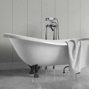 A white freestanding clawfoot bathtub with dark metal legs and a matching wall-mounted faucet, shown in a bathroom setting with a gray towel draped over the side.