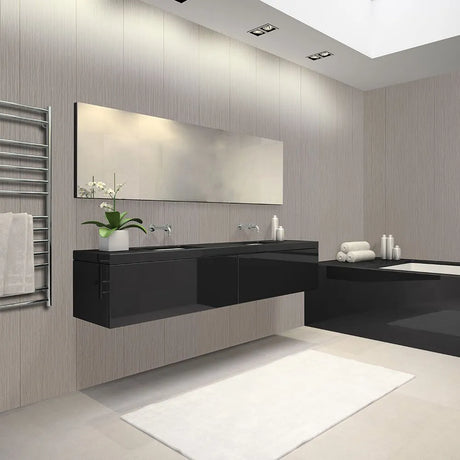 Modern bathroom interior with a floating black double-sink vanity, large rectangular mirror, light wood paneled walls, a white bath mat, towel rack, and bathtub area.