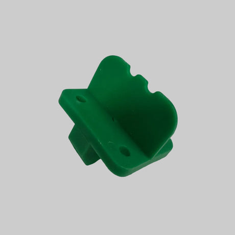 A small green plastic spacer for TimbeX decking 