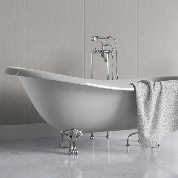 A white freestanding clawfoot bathtub with a polished chrome faucet and a draped gray towel, set against a light gray paneled wall and floor.