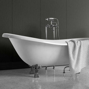 A freestanding white bathtub with ornate silver claw legs and a matching chrome faucet, shown in a bathroom setting with a gray textured towel draped over the side.