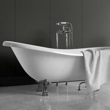 A freestanding white bathtub with ornate silver claw legs and a matching chrome faucet, shown in a bathroom setting with a gray textured towel draped over the side.