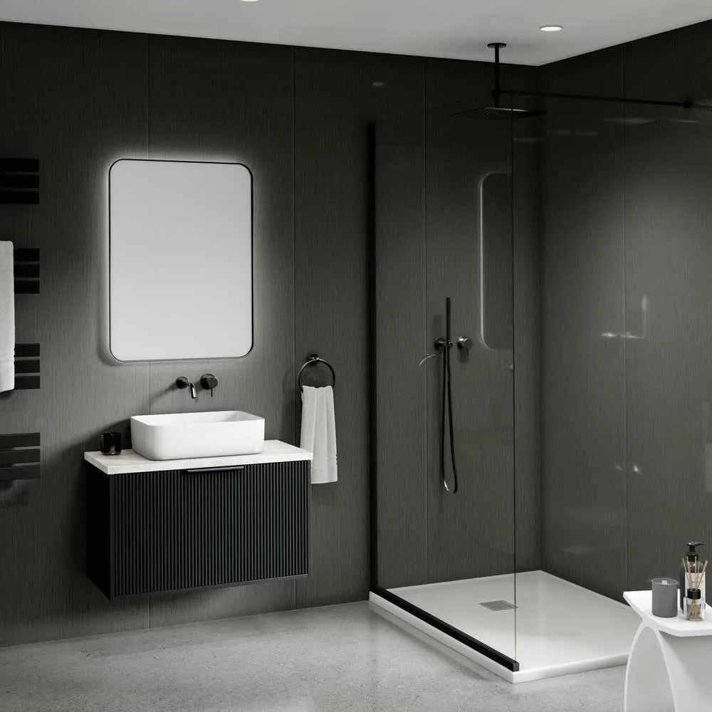 Modern bathroom interior with a floating black vanity, white vessel sink, rectangular mirror, walk-in shower with glass enclosure, dark textured walls, and a small white side table in the foreground.