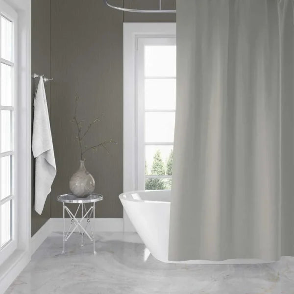 Bathroom with a freestanding bathtub, shower curtain, and decorative elements.