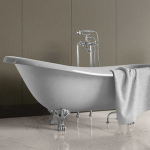A freestanding oval bathtub with claw feet and a polished chrome faucet, shown in a bathroom setting with a gray towel draped over the side.