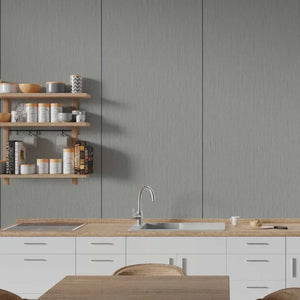 A modern kitchen interior with white cabinets, a light wood countertop, a stainless steel sink and faucet, open wooden shelves with jars and books, and a gray paneled wall behind.