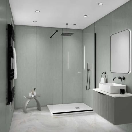 A modern bathroom interior with a walk-in shower area, white vessel sink, wall-mounted vanity, large mirror, black fixtures, and pale gray textured walls and floor.