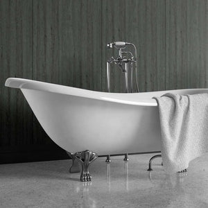 A freestanding white bathtub with ornate silver claw legs and a matching chrome faucet, shown in a bathroom setting with a gray textured towel draped over the side.