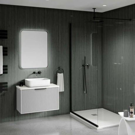 Modern bathroom interior with a floating white vanity, rectangular vessel sink, wall mirror, dark wood-look walls, a glass shower enclosure, and a white bathtub.