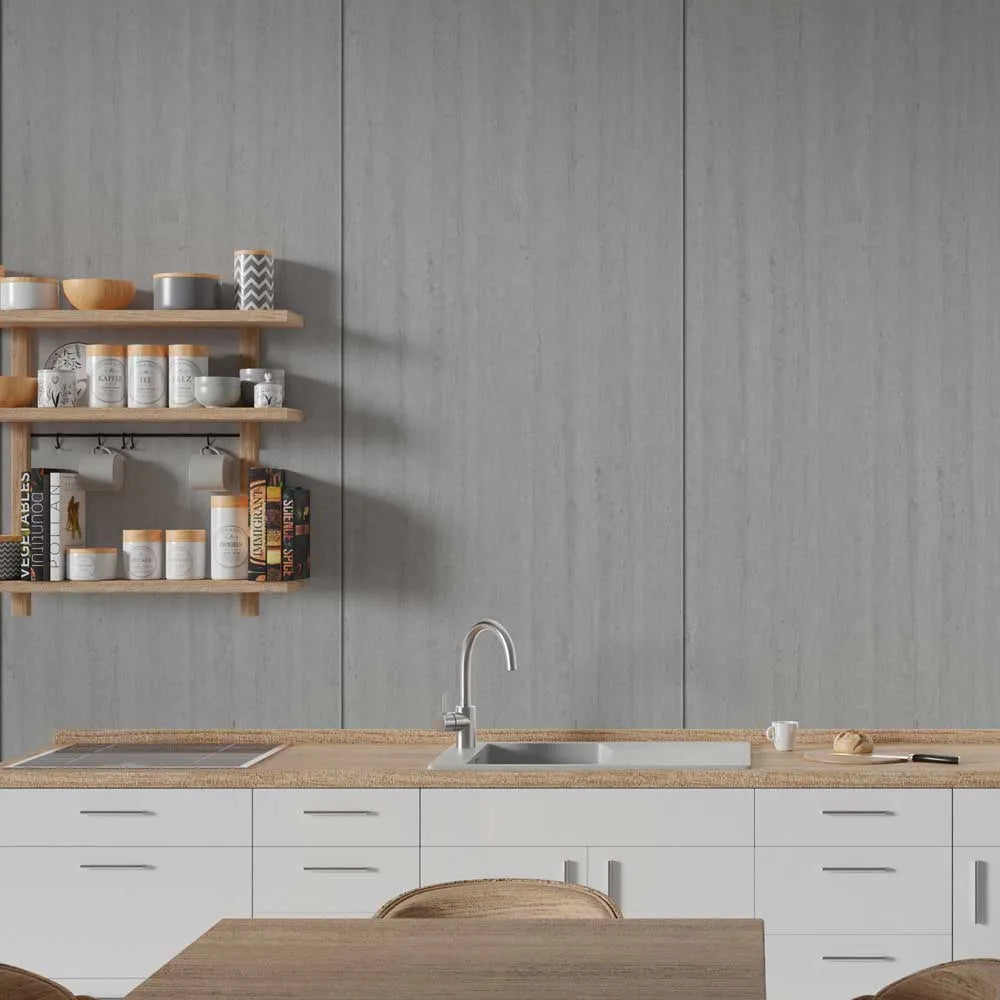 A modern kitchen scene with white lower cabinets, a light wood countertop, a stainless steel sink and faucet, a gray wood-look backsplash wall, and floating wooden shelves holding jars and books.