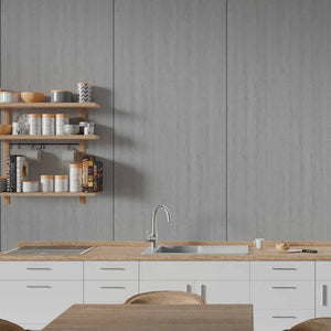 A modern kitchen scene with white lower cabinets, a light wood countertop, a stainless steel sink and faucet, a gray wood-look backsplash wall, and floating wooden shelves holding jars and books.