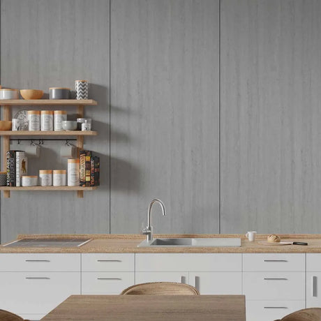 A modern kitchen scene with white lower cabinets, a light wood countertop, a stainless steel sink and faucet, a gray wood-look backsplash wall, and floating wooden shelves holding jars and books.