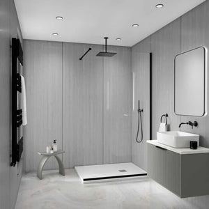 A modern bathroom interior with a walk-in shower enclosure, white vessel sink, wall-mounted vanity, large mirror, black fixtures, and light gray wood-look walls and floor.