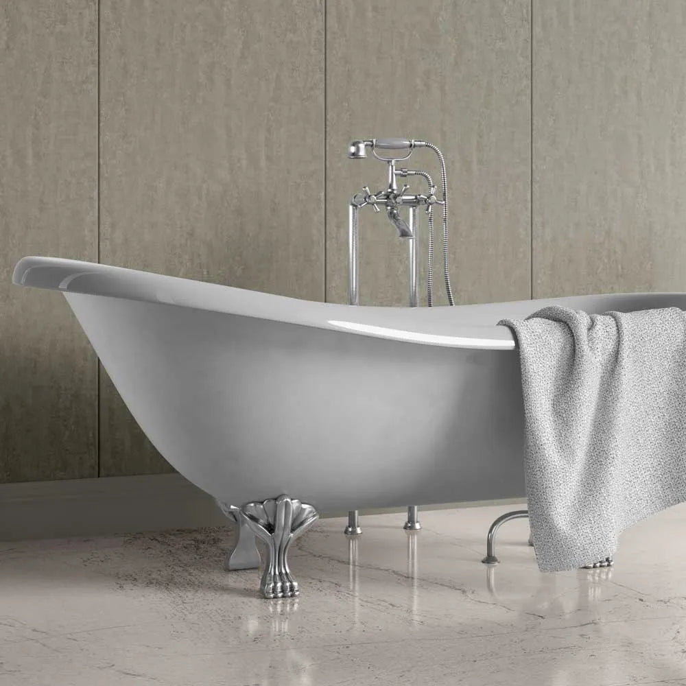 A freestanding oval bathtub with ornate silver claw legs and a matching chrome faucet set, shown in a bathroom with beige wall panels and a light gray towel draped over the side.