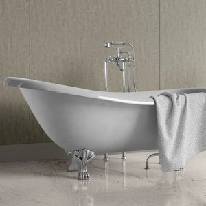 A freestanding oval bathtub with ornate silver claw legs and a matching chrome faucet set, shown in a bathroom with beige wall panels and a light gray towel draped over the side.