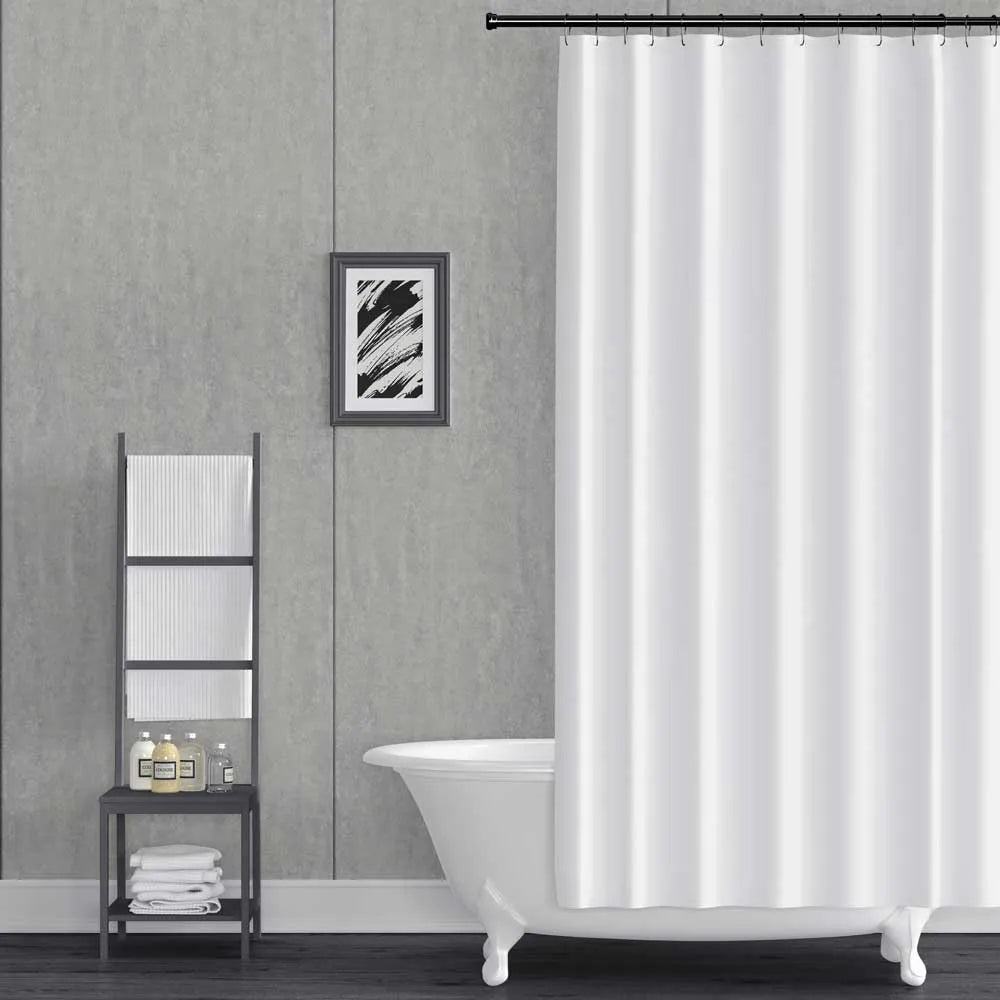 A white fabric shower curtain hanging from a black rod in a modern bathroom setting with a gray textured wall, a white clawfoot tub, and a black metal ladder shelf.