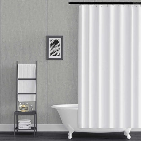 A white fabric shower curtain hanging from a black rod in a modern bathroom setting with a gray textured wall, a white clawfoot tub, and a black metal ladder shelf.