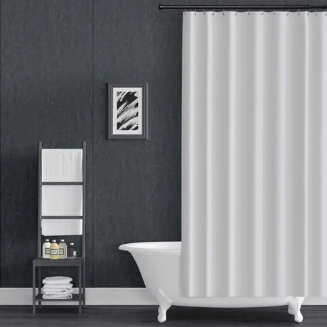 Bathroom with a white shower curtain, bathtub, and towel rack against a dark gray wall.